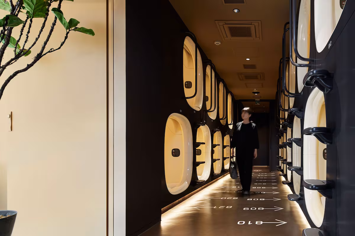 Two tiers of sleeping berths along a corridor in a Tokyo capsule house